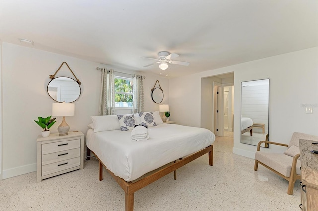 bedroom with ceiling fan, baseboards, and ensuite bath