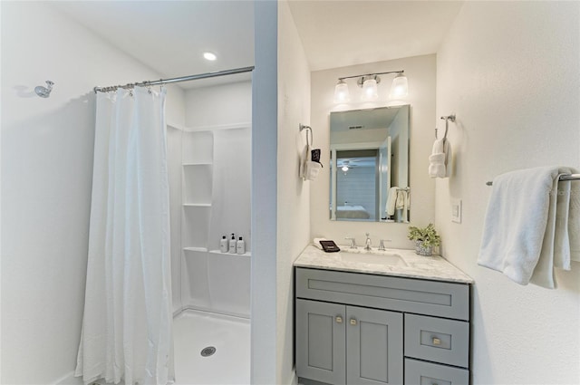 bathroom featuring a stall shower and vanity