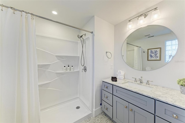 bathroom featuring vanity, a shower with curtain, and visible vents