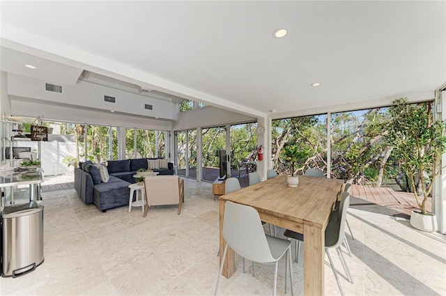 sunroom / solarium featuring visible vents, recessed lighting, and beamed ceiling
