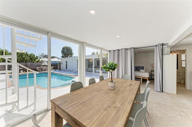 dining area featuring recessed lighting and expansive windows