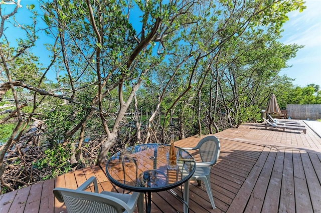 wooden terrace featuring outdoor dining space