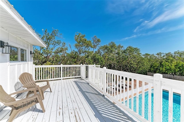 wooden terrace featuring a fenced in pool