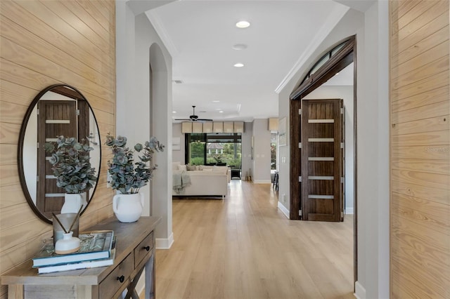 12711 Del Corso Loop, Bradenton, FL 34211 - corridor with ornamental molding, arched walkways, light wood-type flooring, recessed lighting, and wood walls