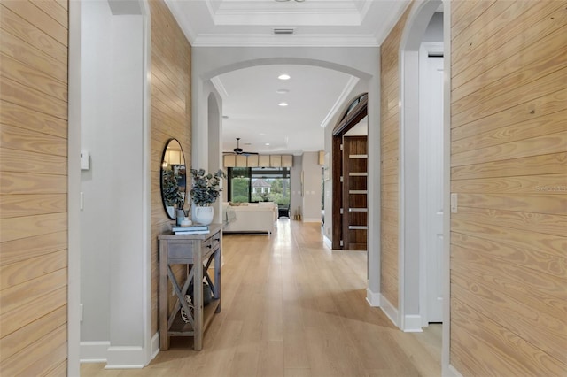 12711 Del Corso Loop, Bradenton, FL 34211 - hallway featuring arched walkways, ornamental molding, light wood-type flooring, and wood walls