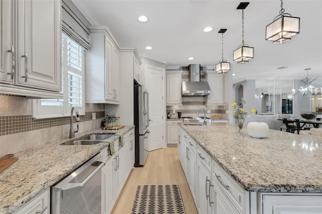 12711 Del Corso Loop, Bradenton, FL 34211 - kitchen featuring wall chimney range hood, stainless steel appliances, a spacious island, white cabinets, and recessed lighting