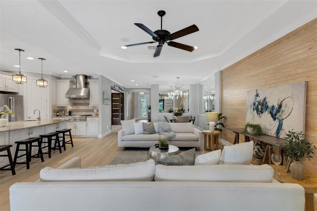 12711 Del Corso Loop, Bradenton, FL 34211 - living room featuring light wood-style flooring, recessed lighting, a chandelier, wood walls, and a ceiling fan