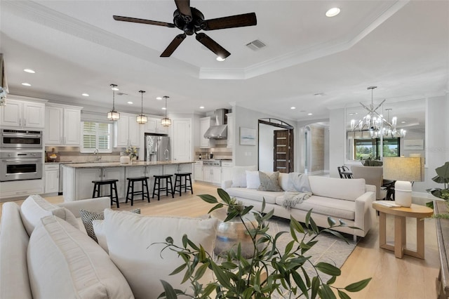 12711 Del Corso Loop, Bradenton, FL 34211 - living area with light wood-style flooring, ornamental molding, ceiling fan, recessed lighting, and a chandelier