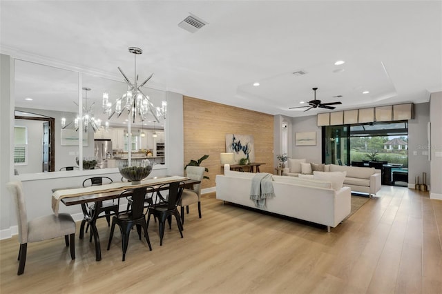 12711 Del Corso Loop, Bradenton, FL 34211 - living room with ceiling fan, recessed lighting, a chandelier, light wood finished floors, and an accent wall