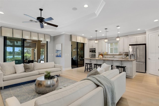 12711 Del Corso Loop, Bradenton, FL 34211 - living area with a ceiling fan, crown molding, recessed lighting, light wood finished floors, and a raised ceiling
