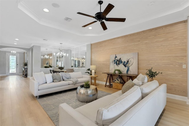 12711 Del Corso Loop, Bradenton, FL 34211 - living area with a chandelier, crown molding, wood walls, light wood-style floors, and recessed lighting