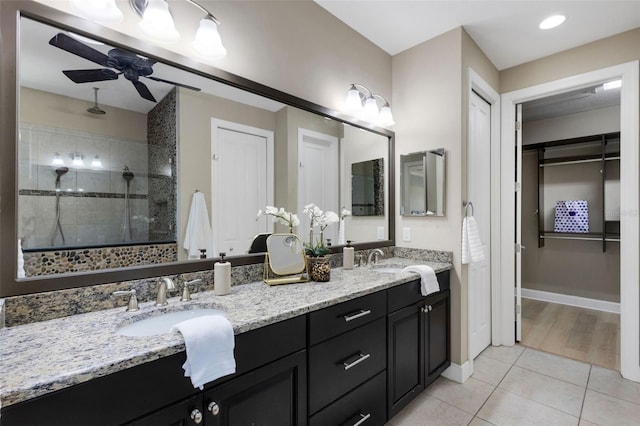 12711 Del Corso Loop, Bradenton, FL 34211 - bathroom with double vanity, tile patterned flooring, a stall shower, ceiling fan, and a spacious closet