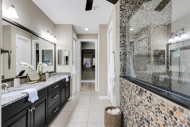 12711 Del Corso Loop, Bradenton, FL 34211 - bathroom with double vanity, a tile shower, tile patterned flooring, a spacious closet, and a ceiling fan
