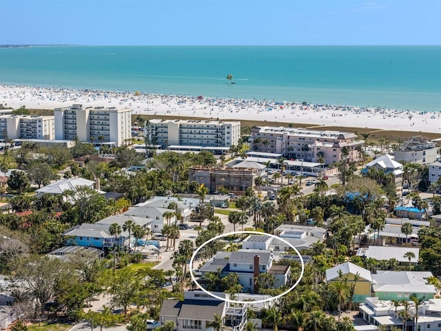 birds eye view of property with a water view and a view of the beach