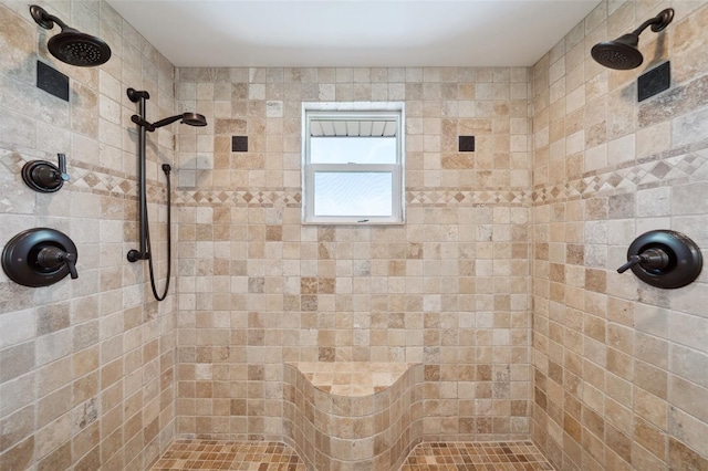 full bath with a tile shower