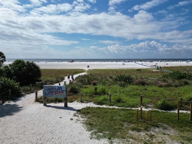 property view of water featuring fence and a view of the beach