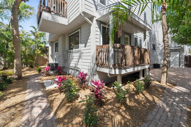 view of side of property with a balcony and central AC