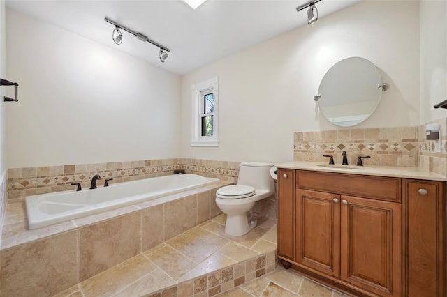 full bath featuring toilet, tasteful backsplash, a bath, and track lighting