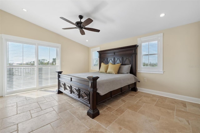 bedroom featuring lofted ceiling, multiple windows, and stone tile flooring