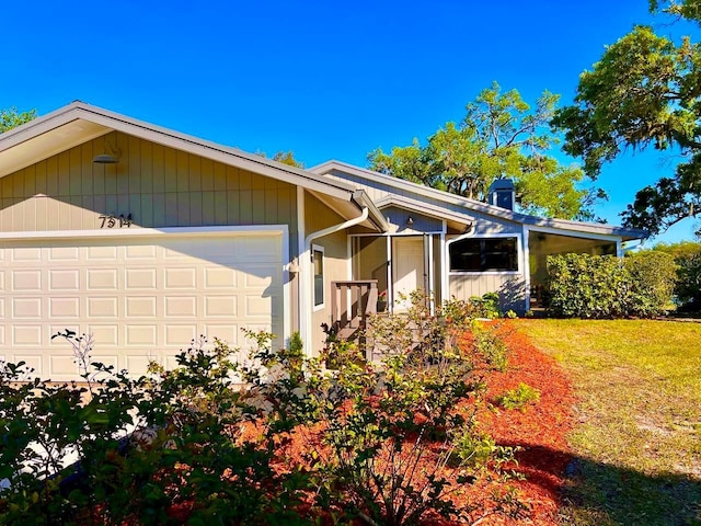 view of front of home with a front yard and a garage