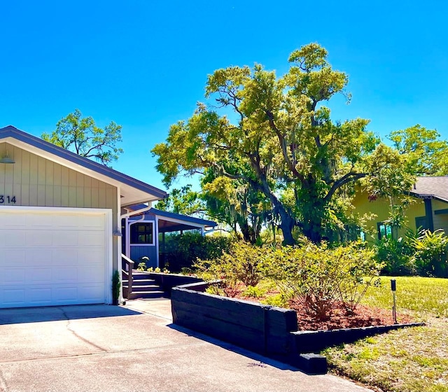 view of property exterior featuring driveway and a garage