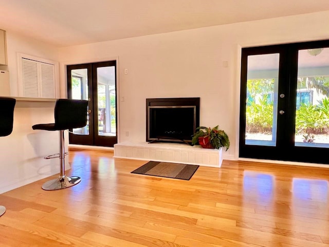 unfurnished living room with wood finished floors and french doors