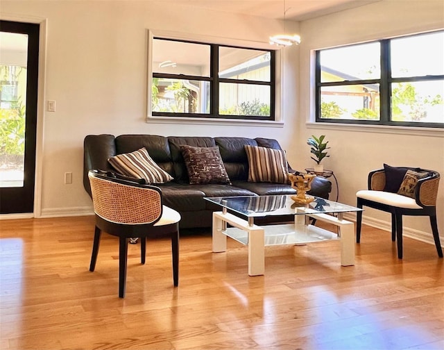 living room with baseboards and light wood-style flooring
