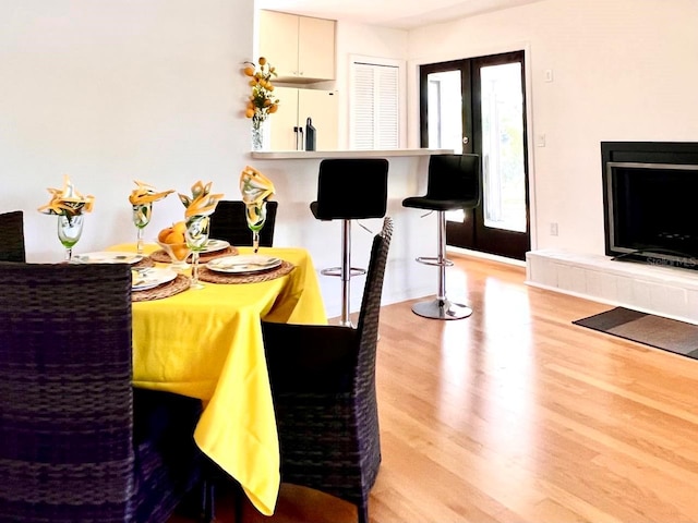 dining area featuring light wood-style flooring and french doors