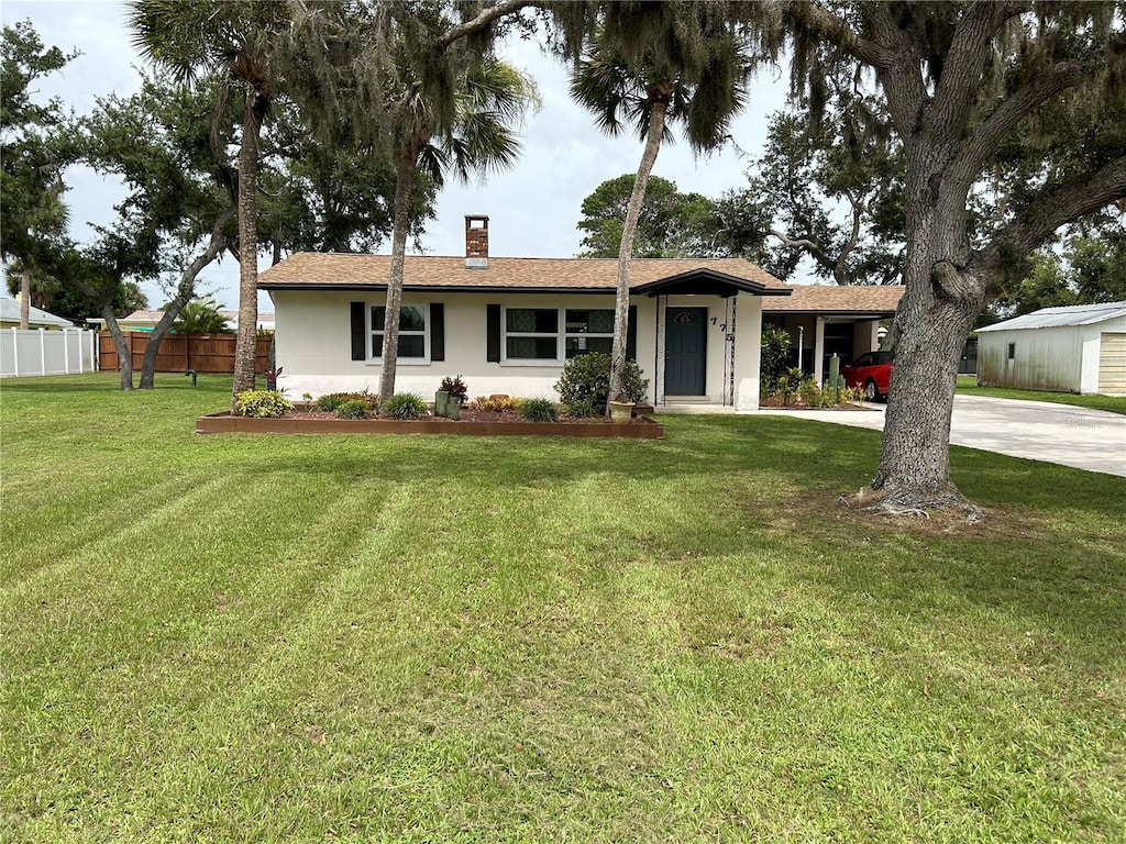 775 Liberty St, Englewood, FL 34223 - single story home with driveway, fence, a chimney, a front lawn, and stucco siding
