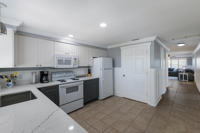 kitchen featuring a sink, white cabinetry, white appliances, visible vents, and ornamental molding