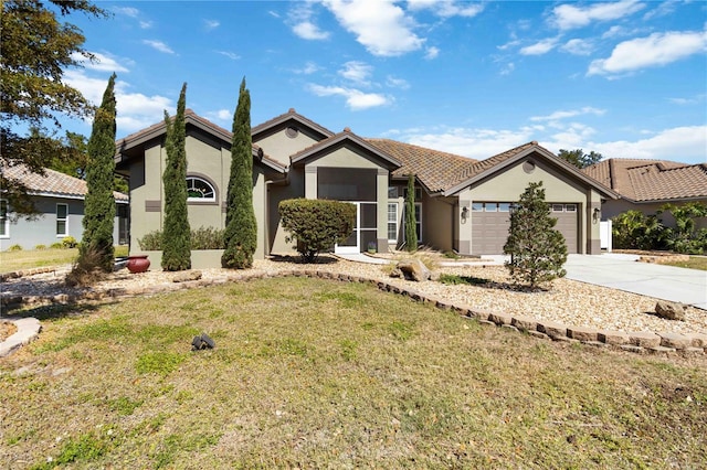 1118 Deardon Dr, Venice, FL 34292 - view of front of home featuring stucco siding, a tiled roof, driveway, a front yard, and a garage