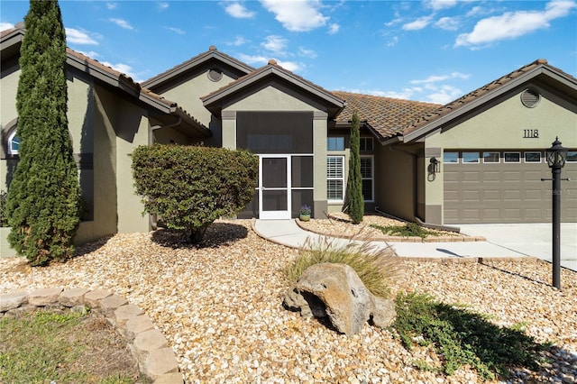 1118 Deardon Dr, Venice, FL 34292 - view of front of house with a garage, driveway, and stucco siding