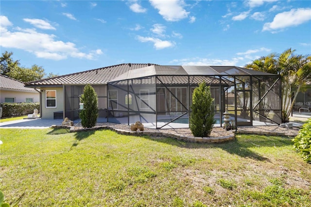 1118 Deardon Dr, Venice, FL 34292 - back of property featuring a tiled roof, a lanai, a patio, a lawn, and stucco siding