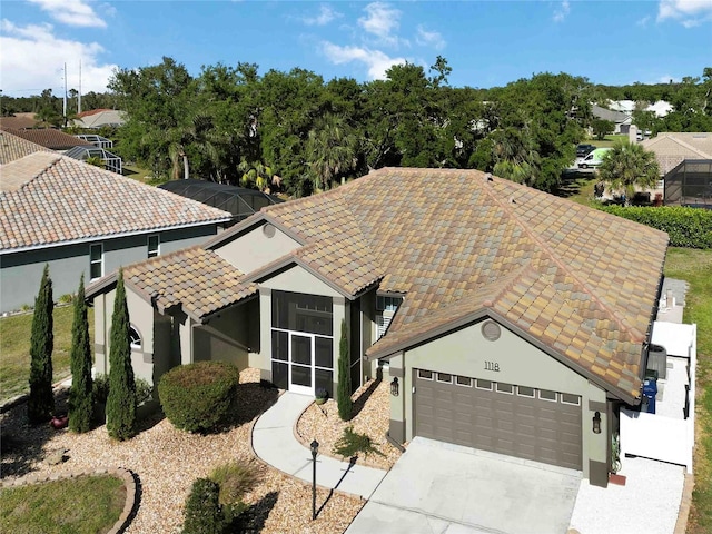 1118 Deardon Dr, Venice, FL 34292 - view of front of property featuring a tile roof, stucco siding, an attached garage, and concrete driveway