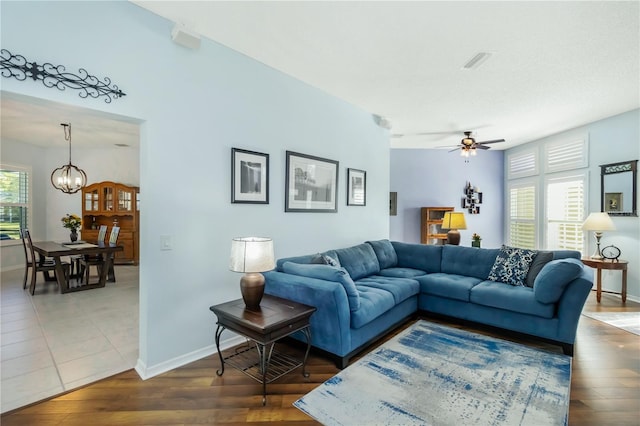 1118 Deardon Dr, Venice, FL 34292 - living room featuring baseboards, visible vents, ceiling fan with notable chandelier, and wood finished floors
