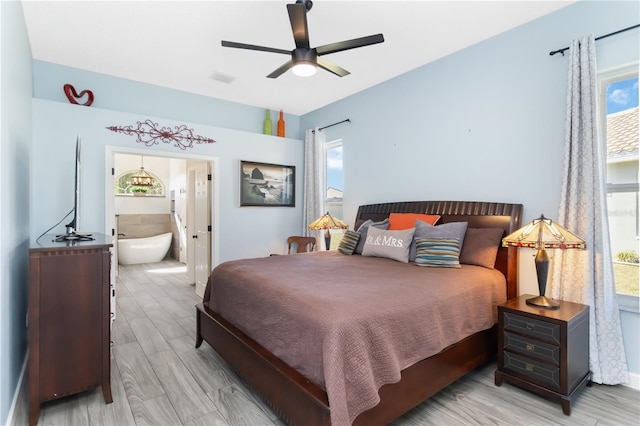 1118 Deardon Dr, Venice, FL 34292 - bedroom with light wood finished floors, visible vents, ceiling fan, and ensuite bath