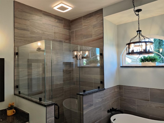 1118 Deardon Dr, Venice, FL 34292 - bathroom featuring tile walls, a stall shower, an inviting chandelier, and a freestanding bath