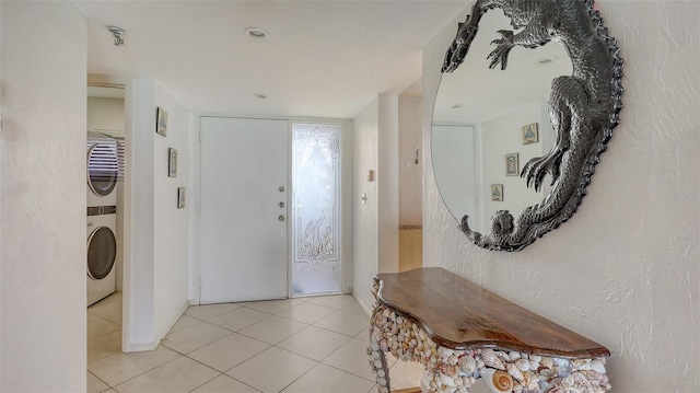 2675 Gulf Of Mexico Dr Unit 403, Longboat Key, FL 34228 - foyer entrance featuring stacked washer and dryer and light tile patterned flooring