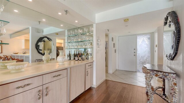 2675 Gulf Of Mexico Dr Unit 403, Longboat Key, FL 34228 - bar featuring baseboards, recessed lighting, and wood finished floors