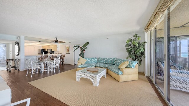 2675 Gulf Of Mexico Dr Unit 403, Longboat Key, FL 34228 - living room featuring a ceiling fan, dark wood-style flooring, and a textured ceiling