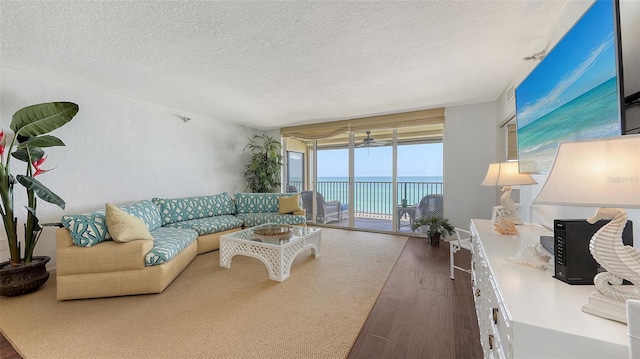 2675 Gulf Of Mexico Dr Unit 403, Longboat Key, FL 34228 - living area featuring a textured ceiling and dark wood-style flooring