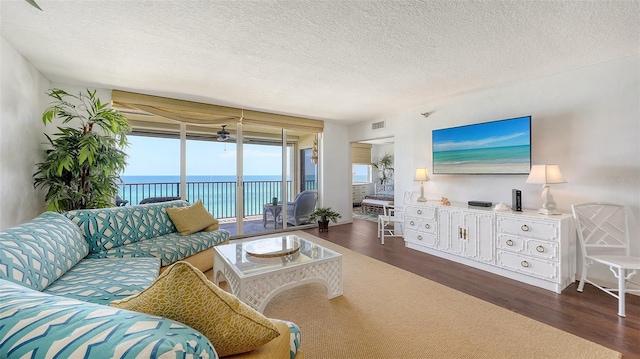 2675 Gulf Of Mexico Dr Unit 403, Longboat Key, FL 34228 - living room with visible vents, a textured ceiling, ceiling fan, and wood finished floors