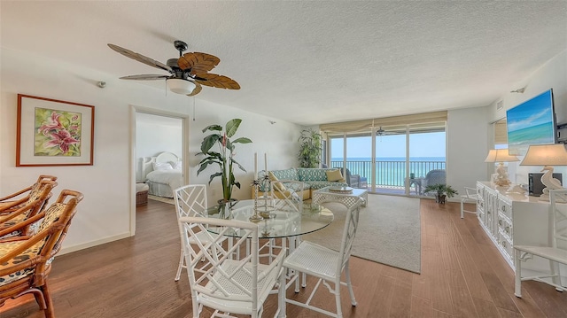 2675 Gulf Of Mexico Dr Unit 403, Longboat Key, FL 34228 - dining area with a textured ceiling, ceiling fan, visible vents, and wood finished floors