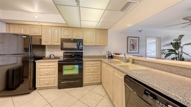 2675 Gulf Of Mexico Dr Unit 403, Longboat Key, FL 34228 - kitchen with light brown cabinetry, visible vents, a sink, and black appliances