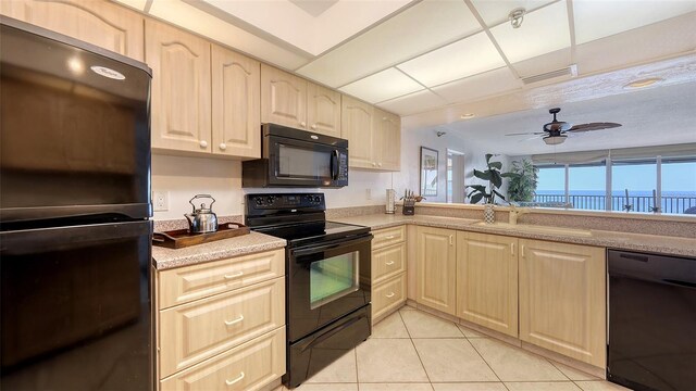 2675 Gulf Of Mexico Dr Unit 403, Longboat Key, FL 34228 - kitchen with a ceiling fan, light brown cabinetry, light countertops, a sink, and black appliances