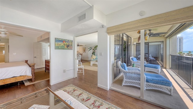2675 Gulf Of Mexico Dr Unit 403, Longboat Key, FL 34228 - bedroom with access to outside, wood finished floors, and visible vents