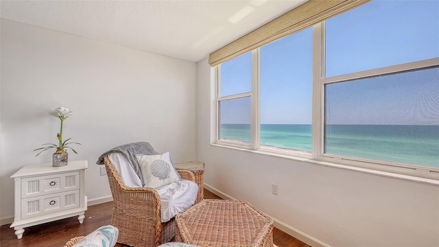 2675 Gulf Of Mexico Dr Unit 403, Longboat Key, FL 34228 - living area featuring baseboards, dark wood-style flooring, and a water view