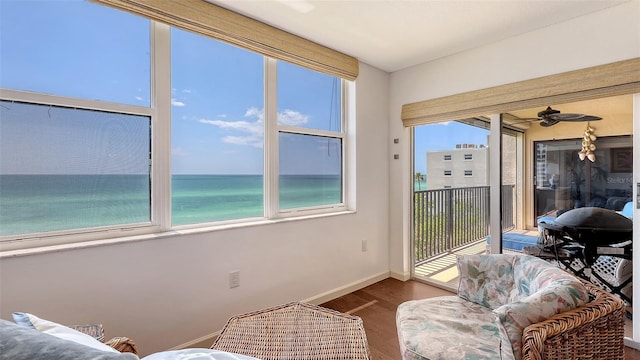2675 Gulf Of Mexico Dr Unit 403, Longboat Key, FL 34228 - sunroom / solarium with baseboards, a water view, and wood finished floors