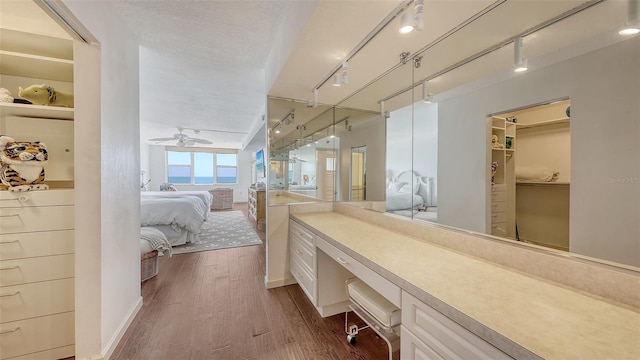 2675 Gulf Of Mexico Dr Unit 403, Longboat Key, FL 34228 - ensuite bathroom featuring ensuite bathroom, rail lighting, a ceiling fan, and wood finished floors