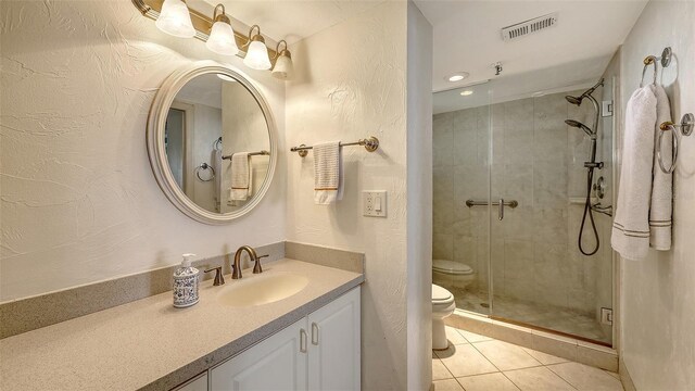 2675 Gulf Of Mexico Dr Unit 403, Longboat Key, FL 34228 - full bath featuring a textured wall, tile patterned flooring, toilet, visible vents, and a stall shower